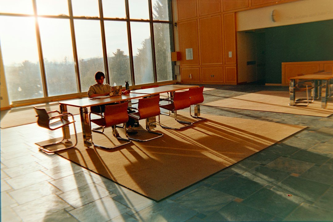 Student reviewing scholarship application paperwork at a university study table